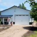RAM 18-426 Front of building showing porch entrance and large garage doors