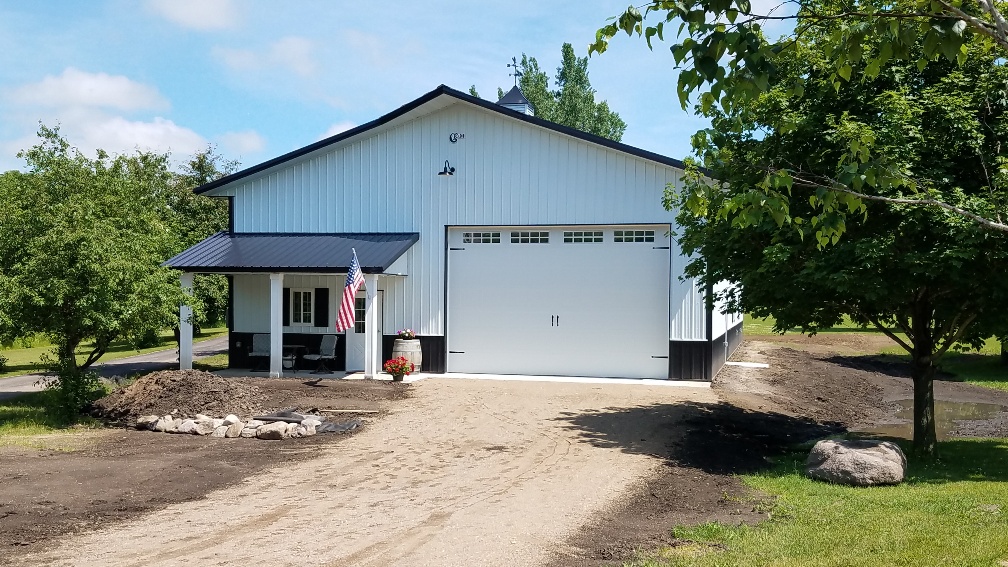 RAM 18-426 Front of building showing porch entrance and large garage doors