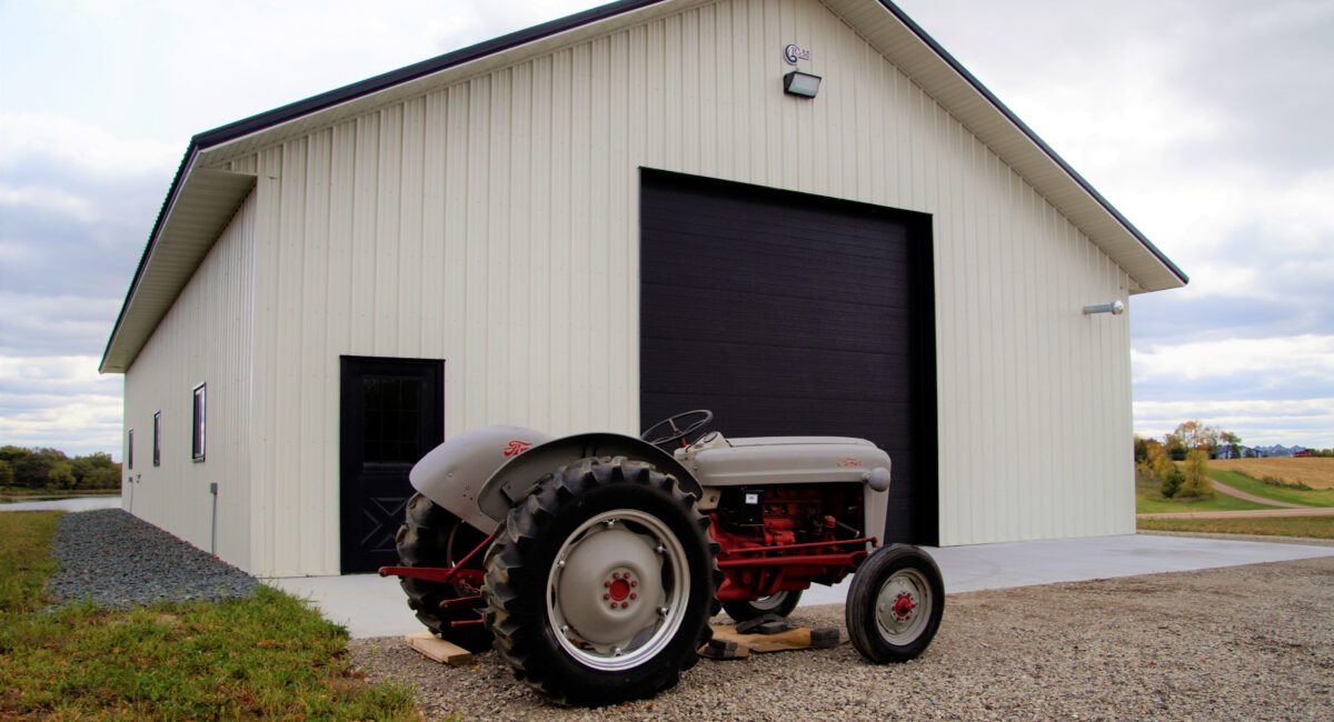 RAM 19-443 Back of building with tractor in front of bifold door