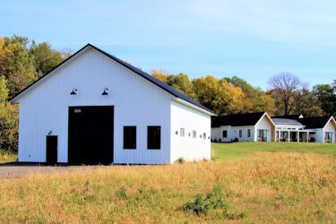 RAM 20-839 Wide angle photo of storage building in front with home in the distance behind