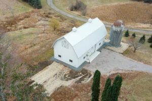 RAM 21-137 Aerial view front left side showing driveway and road behind building