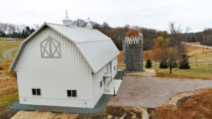 RAM 21-137 Left side view of storage building with driveway and silo on right