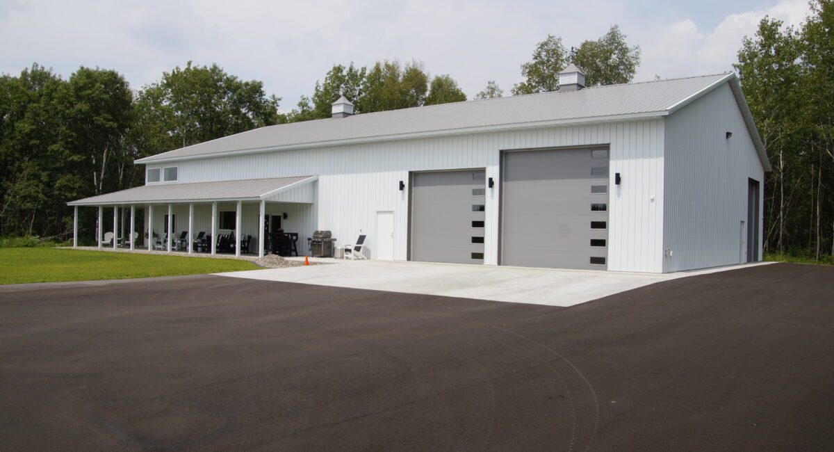 RAM 22-377 Left front view of building showing large double garage doors and driveway