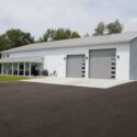RAM 22-377 Left front view of building showing large double garage doors and driveway
