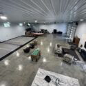 RAM 22-377 Interior of garage/storage space with media area and pickleball court