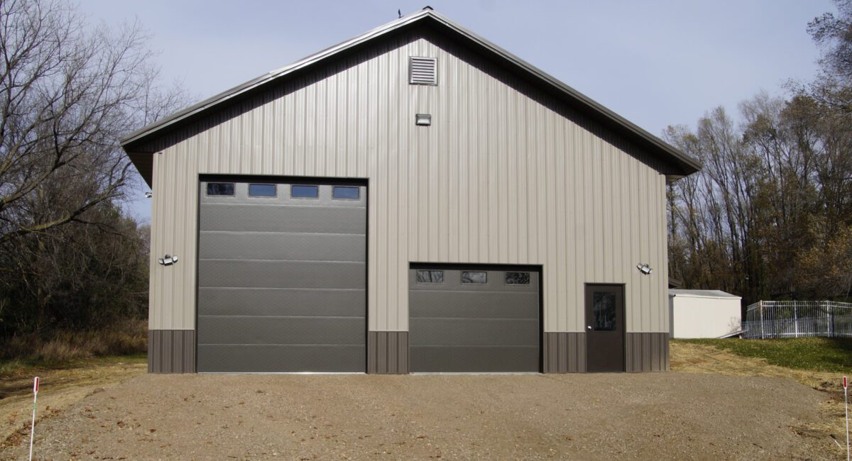 RAM 23-642 Front of building showing large garage door, standard size garage door, and front entrance