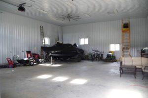 RAM 23-642 Interior of building showing storage space with boat, bikes, and other items